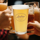 Mocha Stylized Wedding Best Man Name Glass<br><div class="desc">Beer glass for the wedding Best Man that features his name printed in a trendy mocha colour, stylized script inside a mocha colour oval border along with wedding date. Personalize your beer glass by editing and replacing Best Man name and date with your own. Available in many, popular wedding colour...</div>
