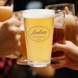 Mocha Stylized Wedding Groomsman Glass<br><div class="desc">Beer glass for the wedding groomsman that features his name printed in a trendy mocha colour, stylized script inside a mocha brown colour oval border along with wedding year date. A great party supply idea for a bachelor party! Personalize your beer glass by editing and replacing name and date with...</div>
