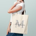 Modern and Elegant Black Personalized Monogram Tote Bag<br><div class="desc">Modern and elegant tote bag features a simple and minimal custom grey and black (colours can be modified) personalized monogram design that can be personalized with an initial and name in script. Perfect gift for your wedding party - maid of honour, bridesmaids, mothers of the bride and groom, and flower...</div>