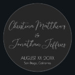 Modern and Elegant Black Wedding Classic Round Sticker<br><div class="desc">This modern and elegant event or wedding sticker features a simple black background with white text. The names of the couple are printed in a script font. The wedding date and location are printed below.</div>