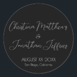 Modern and Elegant Black Wedding Classic Round Sticker<br><div class="desc">This modern and elegant event or wedding sticker features a simple black background with white text. The names of the couple are printed in a script font. The wedding date and location are printed below.</div>