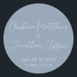 Modern and Elegant Dusty Blue Wedding Classic Round Sticker<br><div class="desc">This modern and elegant event or wedding sticker features a simple dusty blue background with white text. The names of the couple are printed in a script font. The wedding date and location are printed below.</div>