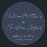 Modern and Elegant Navy Blue Wedding Classic Round Sticker<br><div class="desc">This modern and elegant event or wedding sticker features a simple navy blue background with white text. The names of the couple are printed in a script font. The wedding date and location are printed below.</div>