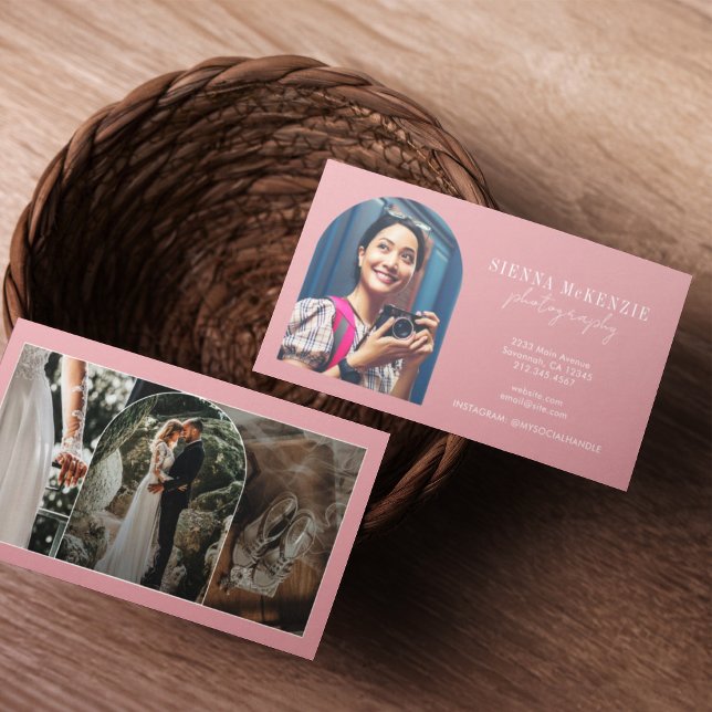 Modern Arch Script Photography Professional Business Card (Two business cards in a woven basket on a wooden table. One card shows a smiling woman with a camera)