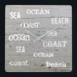 Modern beach driftwood ocean handwritten script square wall clock<br><div class="desc">Modern summer ocean beach clock with driftwood background and sea,  ocean,  beach handwritten script.</div>
