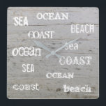 Modern beach driftwood ocean handwritten script square wall clock<br><div class="desc">Modern summer ocean beach clock with driftwood background and sea, ocean, beach handwritten script.</div>