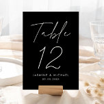 Modern Black and White Script Wedding Table Number<br><div class="desc">Simple, modern wedding table number cards featuring "Table" displayed in a handwritten white script with a black background (or a colour of your choosing). To order the black and white table cards: add your name, wedding date, and table number. Each number needs to be added to your cart individually. After...</div>