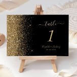 Modern Black Gold Glitter Edge Wedding Table Number<br><div class="desc">The left-hand edge of this elegant modern wedding table number features a gold faux glitter design. The customizable text combines pale gold coloured handwriting,  copperplate and italic fonts on a black background.</div>