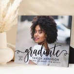Modern Black Script Graduate Photo Graduation Plaque<br><div class="desc">Stylish and elegant graduation plaque sign with easel features a senior photo with "graduate" black script overlay. Personalize the modern custom text with your grad's name,  school,  and class year. Makes a beautiful keepsake to display in your home!</div>