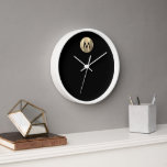 Modern Black White Gold Monogram Clock<br><div class="desc">Modern Luxury Brushed Metallic Gold Stylish Typography Black Background White Frame Home Office Kitchen Living Room Bathroom Clock</div>