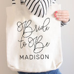 Modern Bride to Be Calligraphy Script Tote Bag<br><div class="desc">Celebrate the bride to be with this chic tote showcasing "Bride to Be" in sweeping modern calligraphy script with a personalized name in clean block type. An ideal keepsake for the engagement party,  bridal shower,  or bachelorette getaway. Name is easy to customize.</div>