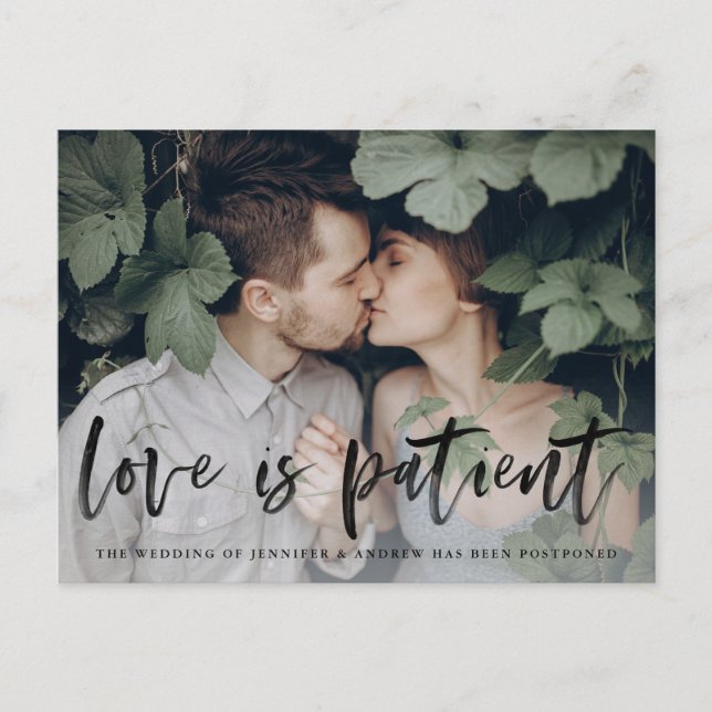 Modern Brush Script Love is Patient Postponement Announcement Postcard (Front)