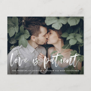Modern Brush Script Love is Patient Postponement Announcement Postcard