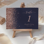 Modern Dark Blue Rose Gold Glitter Edge Wedding Table Number<br><div class="desc">The left-hand edge of this elegant modern wedding table number features a rose gold faux glitter design. The customizable text combines pale rose coloured handwriting,  copperplate and italic fonts on a dark blue background.</div>
