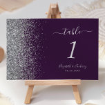 Modern Dark Purple Silver Glitter Edge Wedding Table Number<br><div class="desc">The left-hand edge of this elegant modern wedding table number features a silver faux glitter design. The customizable text combines silver grey handwriting,  copperplate and italic fonts on a dark purple background.</div>