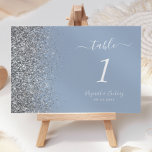 Modern Dusty Blue Silver Glitter Edge Wedding Table Number<br><div class="desc">The left-hand edge of this elegant modern wedding table number features a silver faux glitter design. The customizable text combines white handwriting,  copperplate and italic fonts on a dusty blue background.</div>