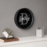 Modern Elegant Monogram Name Black Grey Script Clock<br><div class="desc">The Modern Elegant Monogram Name Black Grey Script Clock is a sophisticated addition to any space, blending functionality with style. Featuring a sleek black face with grey script, this clock is personalized with an elegant monogram and name, making it a unique and refined timepiece. Ideal for home or office settings,...</div>