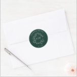 Modern Emerald Green Leafy Crest Monogram Wedding Classic Round Sticker<br><div class="desc">We're loving this trendy, modern emerald green wedding Envelope Seal! Simple, elegant, and oh-so-pretty, it features a hand drawn leafy wreath encircling a modern wedding monogram. It is personalized in elegant typography, Finally, it is trimmed in a delicate frame. View suite here: https://www.zazzle.com/collections/emerald_green_leafy_crest_monogram_wedding-119957580948924617 Contact designer for matching products to complete...</div>