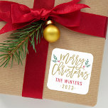 Modern Gold Script Merry Christmas Custom Square Sticker<br><div class="desc">Stylish Merry Christmas holiday favour sticker features antique gold script writing and accents of green branches with holly leaves and red berries. Personalize with custom name / family and year text. The white background colour can be modified.</div>