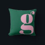 Modern Monogram Initial Letter Preppy Pink Green Throw Pillow<br><div class="desc">This preppy monogram pillow features an oversized lowercase initial in pink against a deep green background. The bold, modern letterform adds personality and charm to teen rooms, dorms, and cozy spaces. Its clean, stylish look makes it easy to mix with colorful decor or classic prep accents. A fun, expressive design...</div>