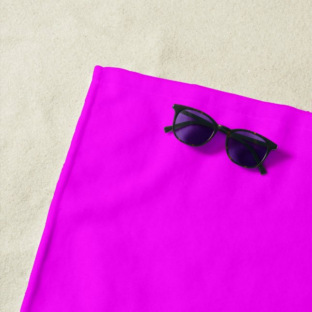 Modern neon magenta pink plain solid colour beach towel (In Situ)