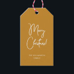 Modern Ochre Calligraphy Script Merry Christmas Gift Tags<br><div class="desc">Modern Christmas gift tag with contemporary calligraphy for "Merry Christmas" on ochre golden background and your family name or other text of choice. This style matches the Christmas wrapping paper in my shop.</div>