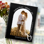 Modern Photo Arch Black Wedding Planner<br><div class="desc">An elegant spiral-bound planner with 60 pages and 12 months, features a single vertical or portrait-oriented wedding photo in a unique arched layout. CHOOSE SOFT OR HARD COVER. Your names are joined with a large white ampersand at the bottom and your wedding date arched at the top. Change the colour...</div>