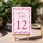 Modern Pink Wavy Frame Wedding Table Number<br><div class="desc">Add a stylish touch to your wedding celebration with these Modern Wavy Frame wedding table cards! The retro design displays "Table" in a handwritten pink script with the table number shown below. A dark pink wavy border surrounds the table number contrasting with a light pink background. The design repeats on...</div>