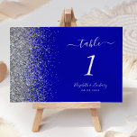 Modern Royal Blue Silver Glitter Edge Wedding Table Number<br><div class="desc">The left-hand edge of this elegant modern wedding table number features a silver faux glitter design. The customizable text combines white handwriting,  copperplate and italic fonts on a royal blue background.</div>