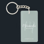 Modern Script Personalized Bridesmaid Keychain<br><div class="desc">Add a personal touch to your wedding with personalized bridesmaid keychain. This keychain features personalized bridesmaid's name in white modern script font style and monogram in sage green modern script font style as background with title and wedding date in white modern sans serif font style on sage green background. Also...</div>