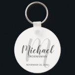 Modern Script Personalized Groomsmen Keychain<br><div class="desc">Add a personal touch to your wedding with personalized groomsmen keychain. This keychain features personalized groomsmen's name in grey modern script font style and monogram in light grey modern script font style as background with title and wedding date in grey modern sans serif font style on white background. Also perfect...</div>