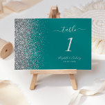 Modern Teal Blue Silver Glitter Edge Wedding Table Number<br><div class="desc">The left-hand edge of this elegant modern wedding table number features a silver faux glitter design. The customizable text combines silver grey handwriting,  copperplate and italic fonts on a teal blue background.</div>