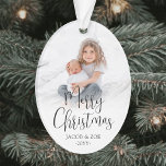 Modern Trendy Script Merry Christmas 2 Photos Oval Ornament<br><div class="desc">Celebrate the simple joys of the holidays with a custom Merry Christmas two photo acrylic oval ornament. The pictures and all wording on this template are easy to personalize and can be different or the same on front and back. The modern minimalist black and white design features trendy script calligraphy,...</div>