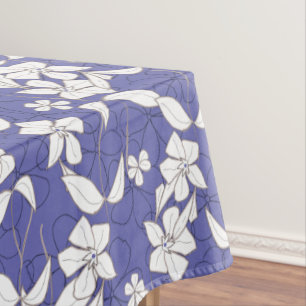 Modern white flowers on a periwinkle tablecloth