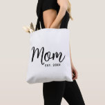 Mom Established Date Black Script New Mom Gift Tote Bag<br><div class="desc">Being a mom is one of the most important jobs in the world. Show your favourite mom that you care with this custom, minimal tote bag. Simple black script calligraphy and black sans serif typography overlay a white tote bag. Personalize with the mom “established” year date when your first child...</div>