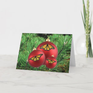 Monarques de cartes de Noël sur des ornements roug