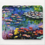 Monet Purple Water Lilies Mouse Pad<br><div class="desc">Monet Purple Water Lilies mouse pad. Oil painting on canvas from c. 1917. French impressionist Claude Monet remains renowned and beloved for the water lily paintings that he created at Giverny. This specific water lily painting features a diverse array of colours including fiery reds, haunting blues, and dreamy purples. A...</div>