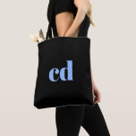 Monogram black light blue initials elegant modern tote bag<br><div class="desc">A classic chic black background. Personalize and add your monogram initials written with light blue block letters. Modern, trendy and simple.</div>