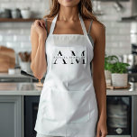 Monogram Black Minimal Apron<br><div class="desc">Elevate your kitchen style with this Monogram Black Minimalist Apron. Featuring a sleek and simple design, this apron combines functionality with elegance, making it perfect for both home cooks and professional chefs. The customizable monogram adds a personal touch, ensuring that you cook in style. Made from durable materials, this apron...</div>