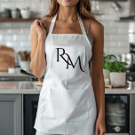 Monogram Black Minimal Apron<br><div class="desc">Elevate your kitchen style with this Monogram Black Minimalist Apron. Featuring a sleek and simple design, this apron combines functionality with elegance, making it perfect for both home cooks and professional chefs. The customizable monogram adds a personal touch, ensuring that you cook in style. Made from durable materials, this apron...</div>