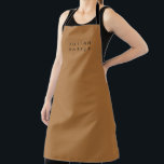 Monogram black minimalist brown apron<br><div class="desc">A sleek and timeless monogram takes centre stage against a rich brown background,  capturing minimalist elegance in its purest form. The juxtaposition of black initials on the warm backdrop creates a balanced and distinguished design,  ideal for adding a touch of personal refinement to any setting.</div>