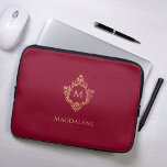 Monogram Burgundy Elegant Vintage Faux Gold Crest Laptop Sleeve<br><div class="desc">An elegant burgundy and gold design with the monogram initial in a vintage crest, recommended for a woman. The crest is faux gold foil, the background is burgundy. Under the crest, in small caps, there is the name in golden caps. The vintage floral crest from an old book cover binding,...</div>