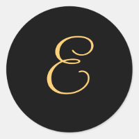 Monogram E, gold coloured initial E on black,
