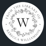 Monogram Floral Wreath From the Library Bookplate Classic Round Sticker<br><div class="desc">Add an elegant touch to all your favourite books with our chic Floral Wreath Monogram From the Library of Bookplate, featuring your single initial monogram in classic serif lettering, framed by a hand-drawn wreath of flowers, buds and tiny botanical leaves. "From the library of" appears in a gorgeous circular arc...</div>