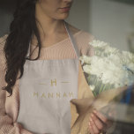 Monogram Gold Grey | Minimalist Elegant Modern Apron<br><div class="desc">A simple stylish custom monogram design in a gold modern minimalist typography on an elegant minimalist soft taupe grey background. The monogram initials and name can easily be personalized along with the feature line to make a design as unique as you are! The perfect bespoke gift or accessory for any...</div>