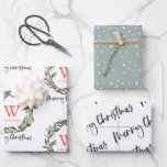 Monogram Wreath Merry Christmas Holiday Wrapping P Wrapping Paper Sheet<br><div class="desc">This cute holiday wrapping paper features a set of 3 different designs of wrapping papers. 1. A white background with a monogram and a greenery wreath. 2. A pistachio green background with snow patterns. 3. A white background with "merry christmas" in script lettering. Change the background colour and personalize it...</div>