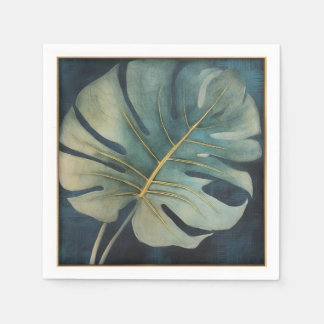 Monstera leaf with gold detail and dark blue napkin