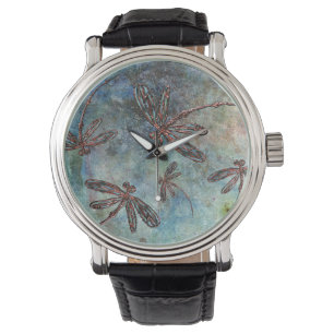 Montre Des libellules en bronze sur un ciel magique.