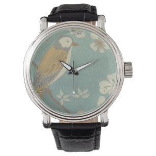 Montre Oiseau jaune, gris et beige perché sur une branche