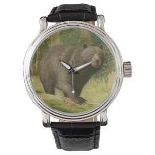 Montre Ours noir faisant un pas sur un tronc d'arbre